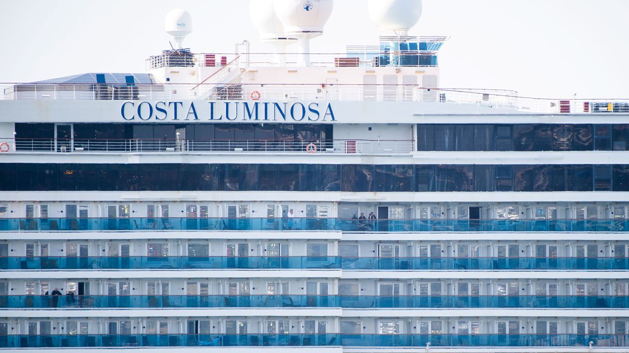 Costa Luminosa passengers are seen as the ship is moored in the harbor in Marseille, France.