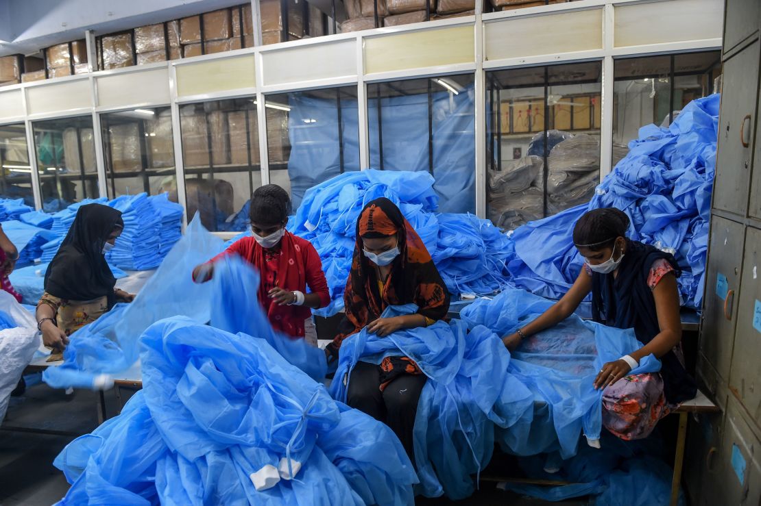 Workers prepare protective clothing and gear at a facility of personal protective equipments manufacturer Nikshe Multiproducts on the outskirts of Ahmedabad on April 2, 2020.