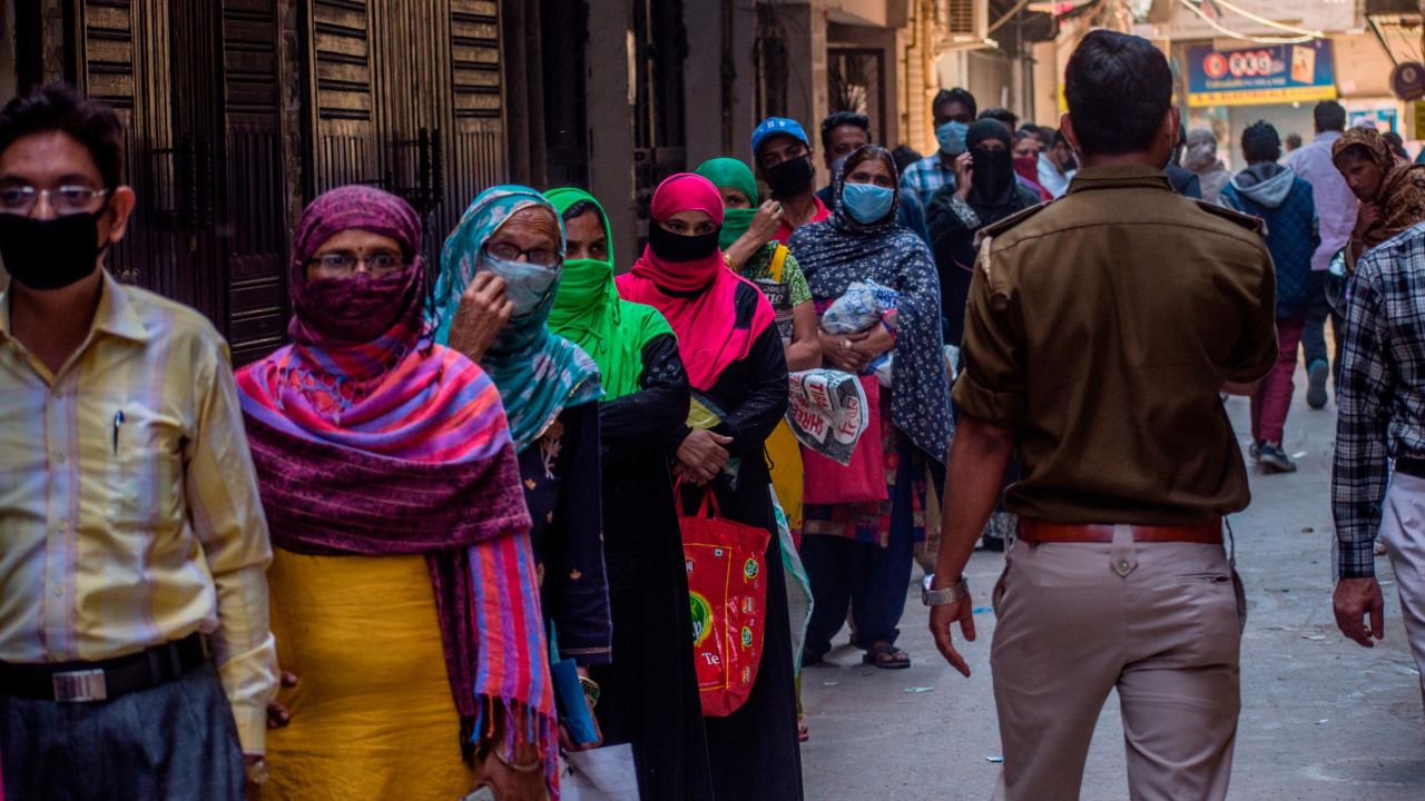 Indians wait to receive rations during the nationwide lockdown on April 2, 2020 in New Delhi.