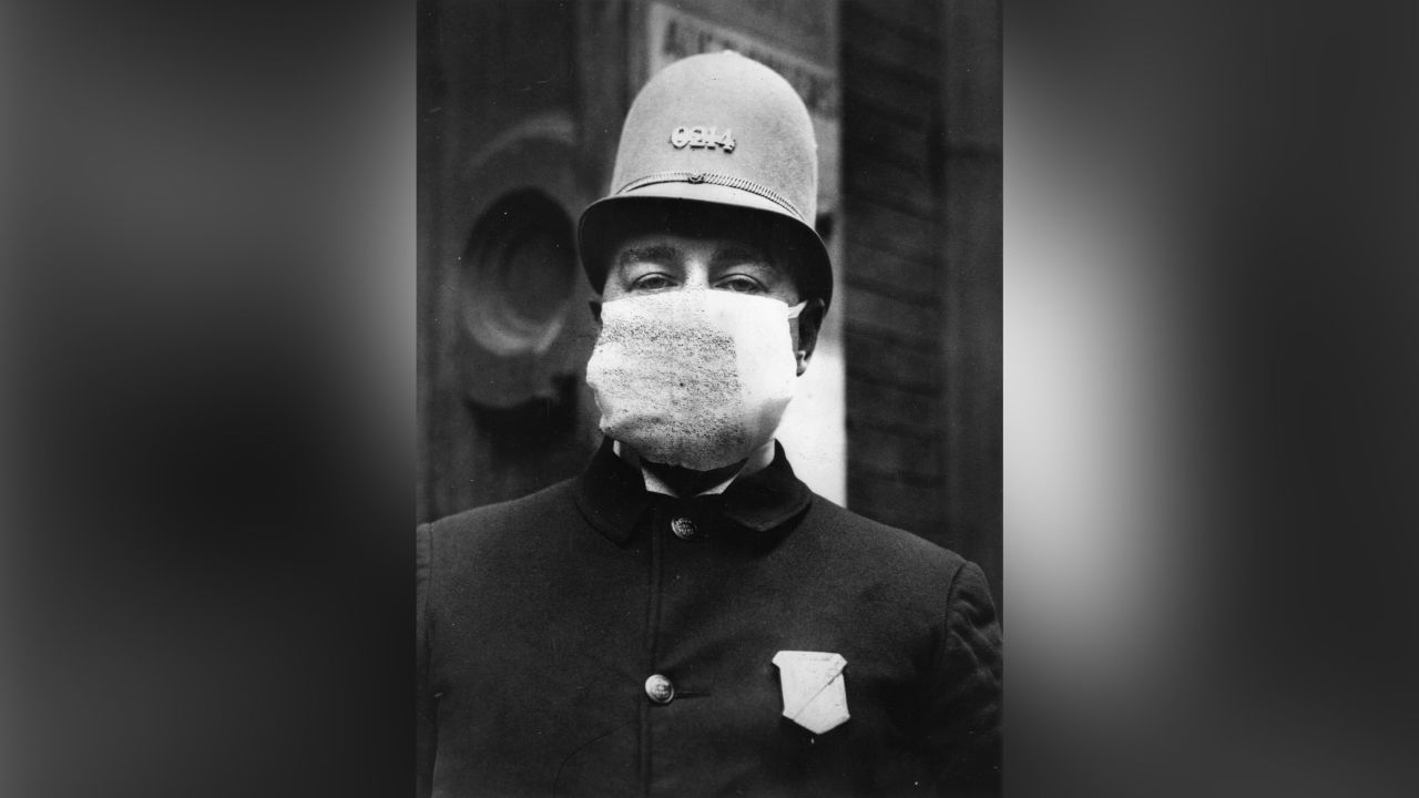 An American policeman wearing a "flu mask" to protect himself from the outbreak of Spanish Flu following World War I.   