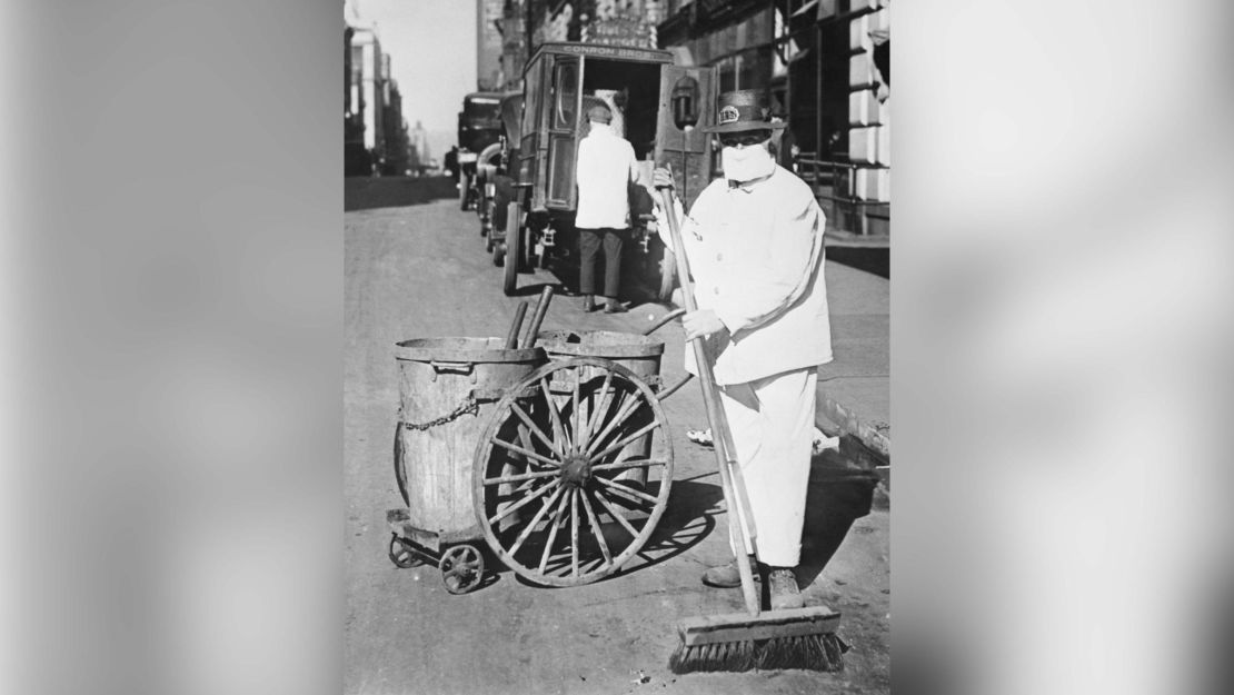A New York Street cleaner wearing a mask to check the spread of the influenza epidemic. "Better be ridiculous then dead," is the view of one official.