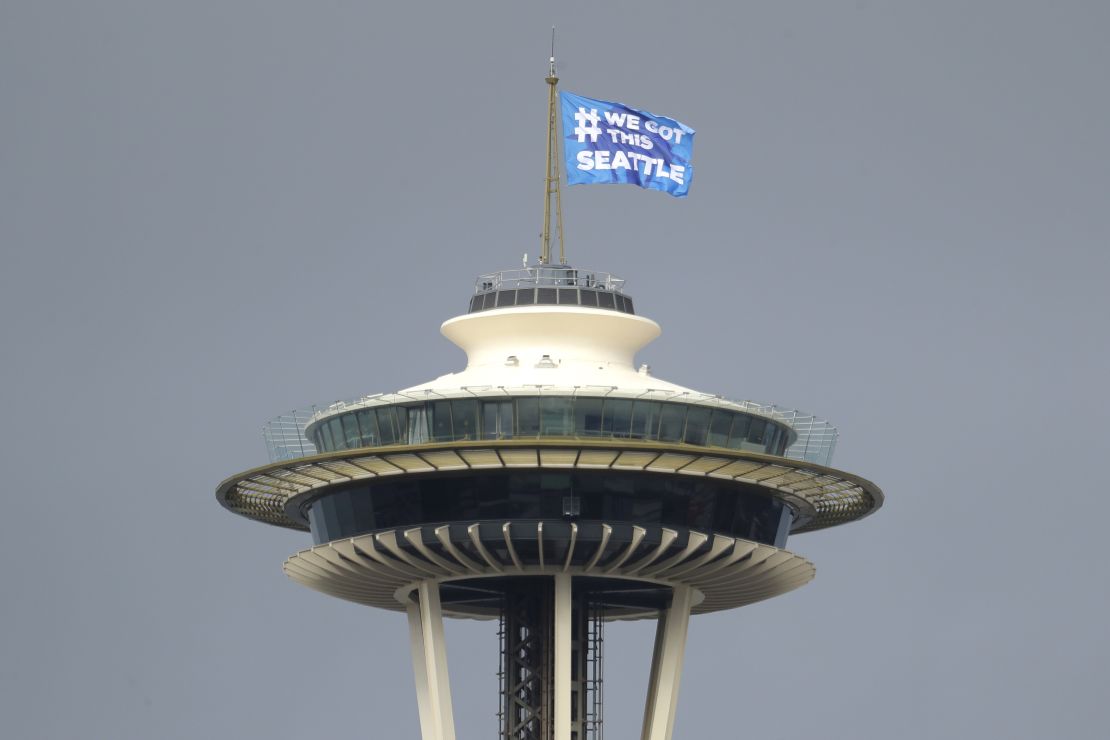 Seattle Mayor Jenny Durkan raises a flag on the roof of the Space Needle reading, "#We Got This Seattle," saying it was intended as a symbol of encouragement and solidarity.
