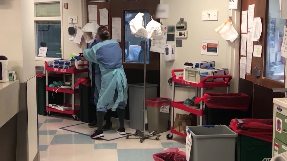 Medical staff work in the hallway of the Covid-19 intensive care unit at Harborview Medical Center in Seattle.