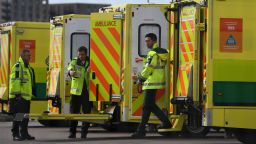 London Ambulance staff members are seen with vehicles in the car park at the ExCeL London exhibition centre in London on April 1, 2020, which has been transformed into the NHS Nightingale Hospital to help with the novel coronavirus COVID-19 pandemic. - Britain reported a record daily coronavirus toll of 381 on March 31, including a 13-year-old boy, more than double the number of nationwide deaths posted in the previous 24 hours. (Photo by DANIEL LEAL-OLIVAS / AFP) (Photo by DANIEL LEAL-OLIVAS/AFP via Getty Images)