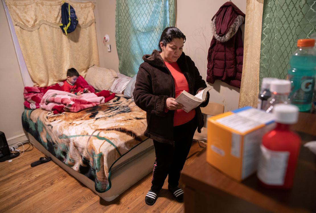 An undocumented Honduran immigrant reads her Bible during self-quarantine with her family for possible COVID-19 on March 30, 2020 in New York. (Photo by John Moore/Getty Images)