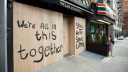 An inspirational message is painted on a boarded up business as New York City attempts to slow down the spread of coronavirus through social distancing on April 2, 2020. 