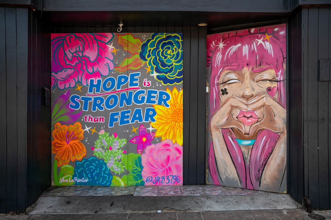 Art adorns the boarded-up Bijou Lounge in Austin, Texas, on March 24. Bar owners on the street commissioned graffiti artists from the HOPE Outdoor Gallery to provide an uplifting message amid the coronavirus pandemic.