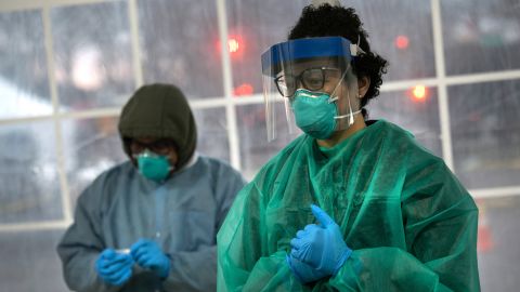 A doctor from SOMOS Community Care prepares to test a patient at a drive-thru testing center for coronavirus at Lehman College on March 28, 2020 in the Bronx, New York City.