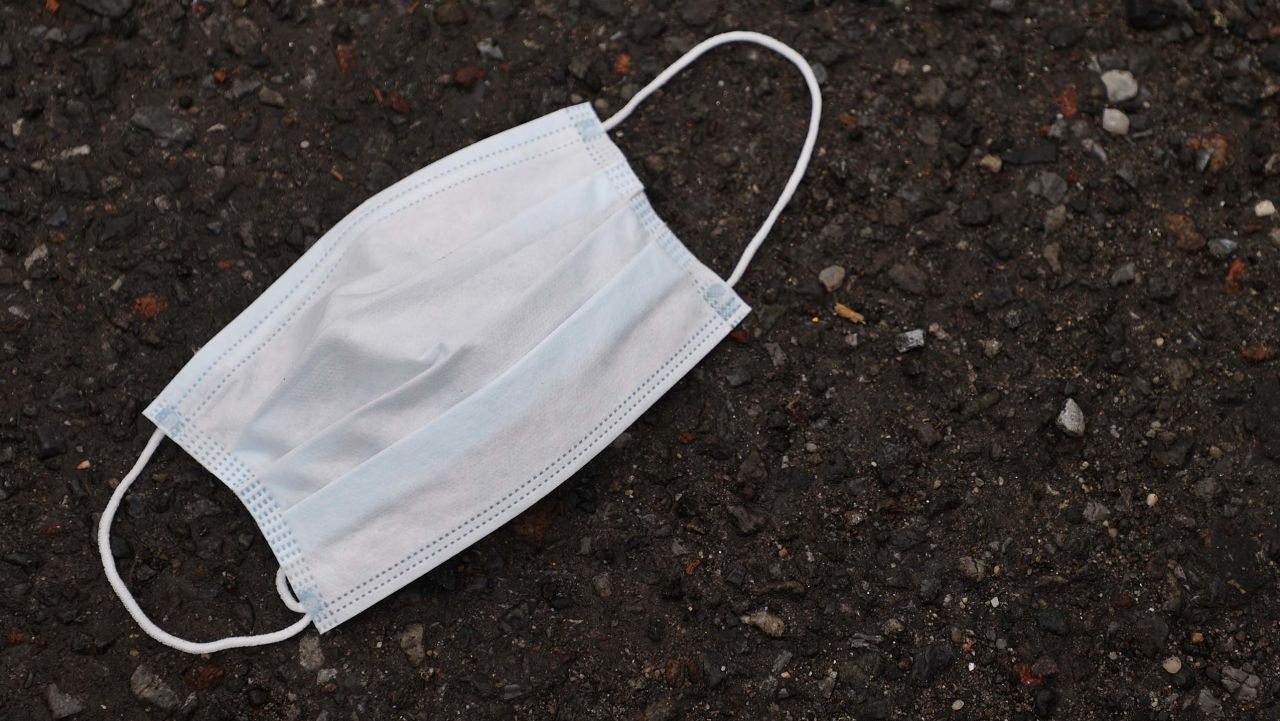 MERRICK, NEW YORK - MARCH 31:  A used mask lies outside of Pat's Farms grocery store on March 31, 2020 in Merrick, New York. Since the coronavirus pandemic people have been discarding used masks on the ground rather than dispensing them in the trash. The World Health Organization declared coronavirus (COVID-19) a global pandemic on March 11.  (Photo by Al Bello/Getty Images)