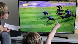 Young fans watch a screening of the Virtual Grand National, which was aired on UK television.