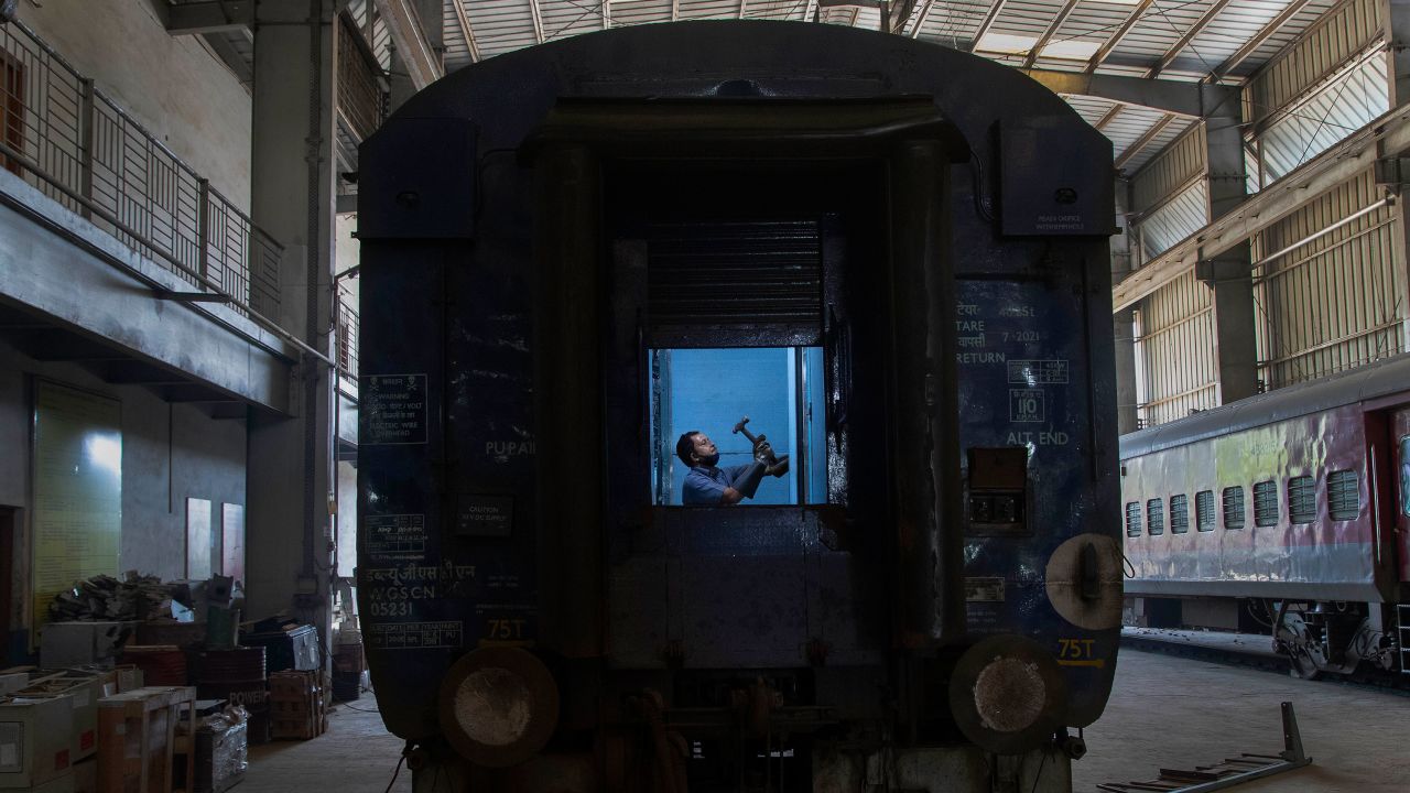 An Indian railway employee works to convert a train coach into an isolation ward for the fight against the new coronavirus in Gauhati, India, Sunday, March 29, 2020.  