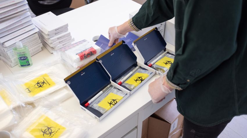 A man packages Covid-19 test kits for shipping at Rightangled, a London-based company that supplies test kits to order online.