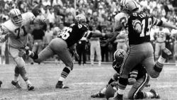 FILE - In this Nov. 8, 1970, file photo, New Orleans Saints' Tom Dempsey (19)  moves up to kick a 63-yard field goal as teammate Joe Scarpati holds the ball, Detroit Lions' Alex Karras (71) rushes in, and Saints' Bill Cody (66) blocks, in New Orleans. The record-setting kick, with 2 seconds left in the game, gave the Saints a 19-17 win. Karras is taking on the role of lead plaintiff: He and his wife, Susan Clark, are two of 119 people who filed suit Thursday, April 12, 2012, in U.S. District Court in Philadelphia, the latest complaint brought against the NFL by ex-players who say the league didn't do enough to protect them from head injuries. (AP Photo/Files)