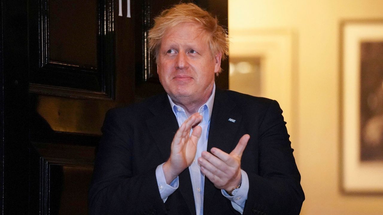 Johnson claps outside 11 Downing Street to salute local heroes during Thursday's nationwide Clap for Carers NHS initiative.