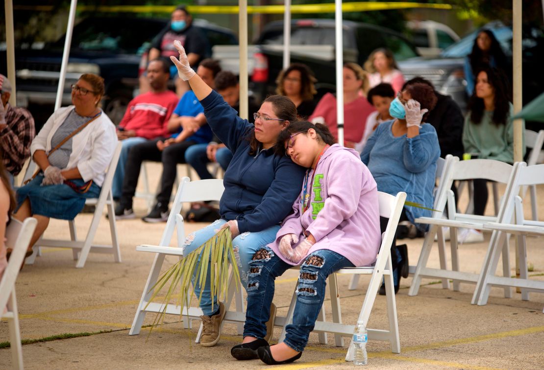 Parishioners attend a Palm Sunday worship service at City On A Hill Church in Houston, Texas. The service was held in the church's parking lot and the church practiced social distancing during the service.