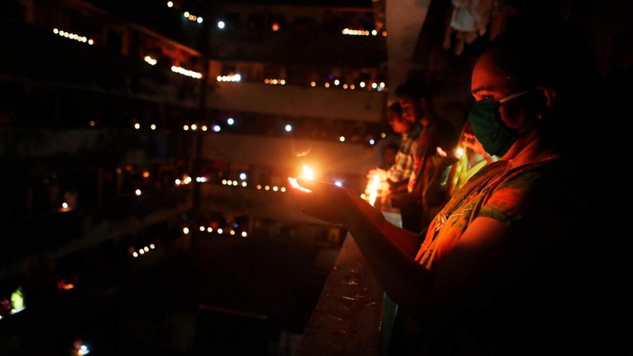 Indians light lamps to mark the country's fight against the Covid-19 pandemic in Mumbai, India, Sunday, April 5, 2020. Indian Prime Minister Narendra Modi had in a Friday broadcast urged the country's 1.3 billion people to switch off lights of their home at 9 pm for 9 minutes on Sunday night and light candles, lamps and even use mobile torches standing in their balconies. Modi said that such a gesture will dispel the darkness created by the coronavirus and show that people are together in their fight against the epidemic. (AP Photo/Rafiq Maqbool)