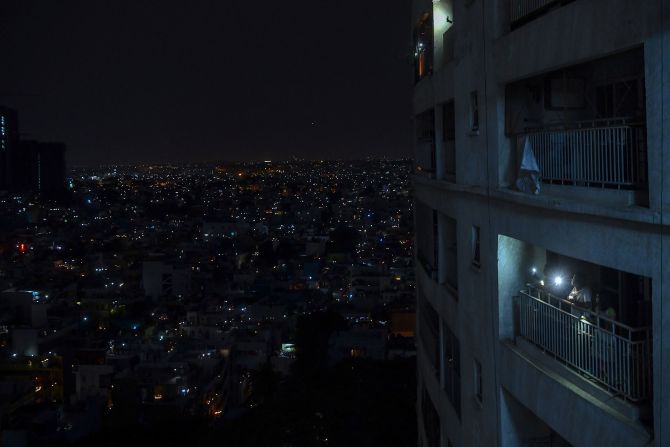 People shine lights from their balcony during a <a href="https://www.cnn.com/2020/04/05/world/india-coronavirus-candlelight-vigil/index.html" target="_blank">nationwide candlelight vigil</a> in Bangalore, India, on April 5, 2020.
