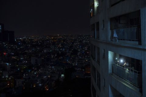 People shine lights from their balcony during a nationwide candlelight vigil in Bangalore, India, on April 5, 2020.