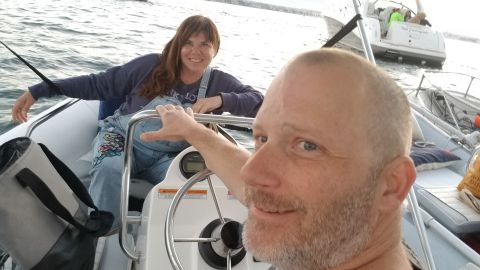 Airbnb hosts Chris (left) and Marty Morrow on their boat in San Diego County in August 2019. They are temporarily living on their boat to make their home available for longer-term stays on Airbnb.  
