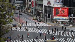 People cross an intersection usually filled with people in the Shibuya area in Tokyo on April 5, 2020.