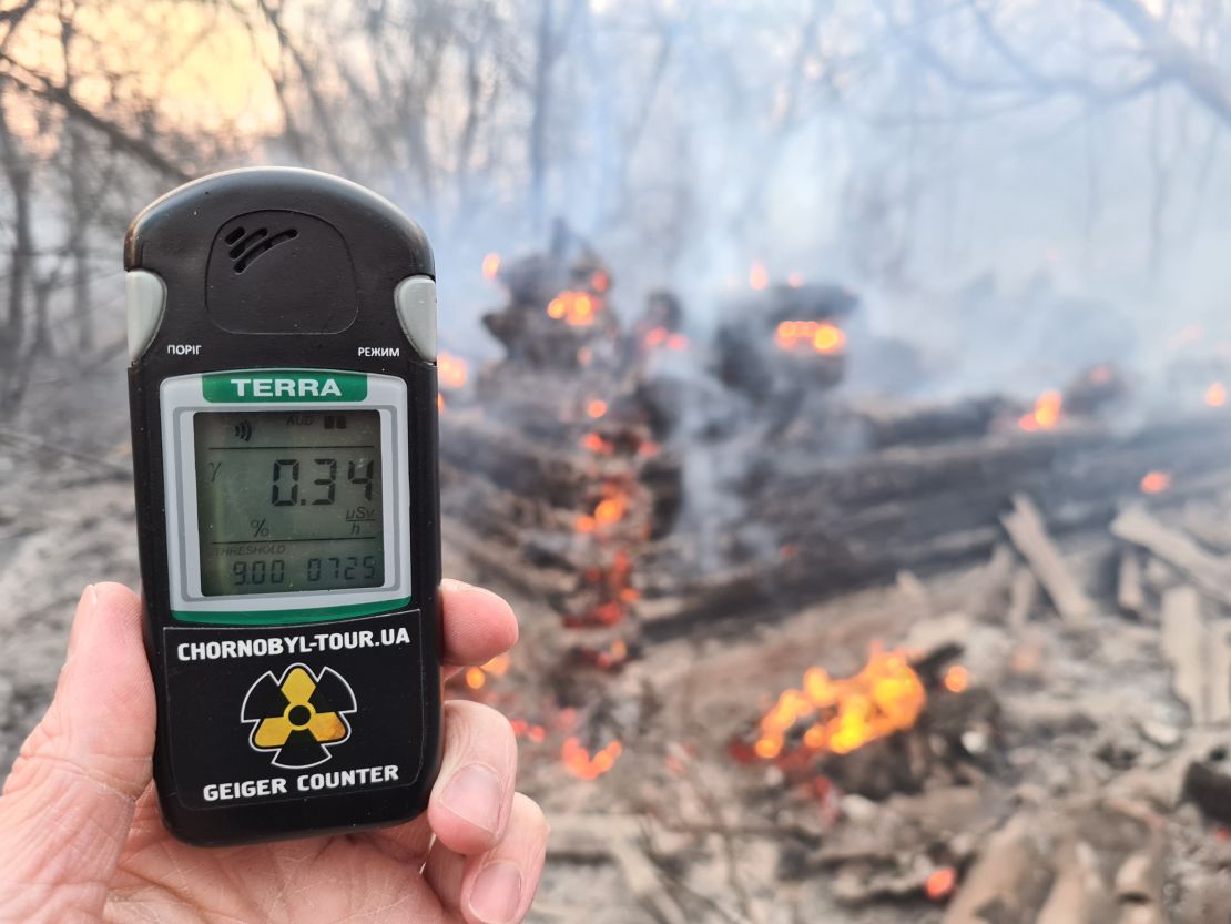 A Geiger counter near the site of the fire on Sunday shows a radiation level slightly below the maximum permissable amount. Other footage taken near the fire shows higher readings.