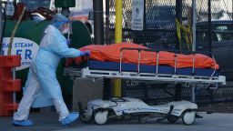 A body is moved to a refrigerator truck serving as a temporary morgue outside of Wyckoff Hospital in the Borough of Brooklyn on April 4, 2020 in New York. - New York state's coronavirus toll rose at a devastating pace to 3,565 deaths Saturday, the governor said, up from 2,935 the previous day, the largest 24-hour jump recorded there. (Photo by Bryan R. Smith / AFP) (Photo by BRYAN R. SMITH/AFP via Getty Images)