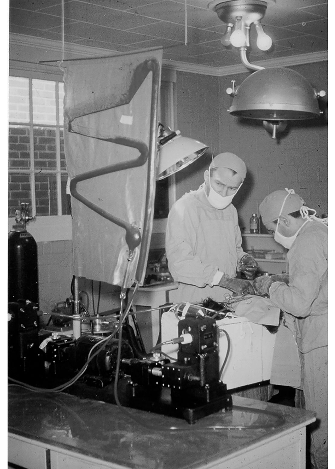 Dr. Francis Robicsek with the heart-lung machine he helped build to perform open-heart surgeries. 