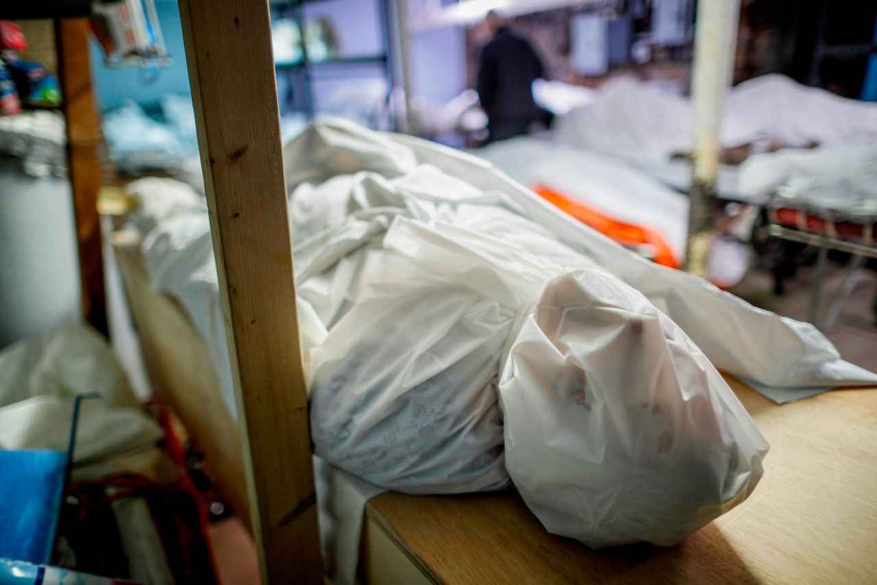 Bodies are wrapped in protective plastic in a holding facility at the Daniel J. Schaefer Funeral Home on Thursday, April 2. Funeral directors are seeing a surge of clients because of the coronavirus pandemic.