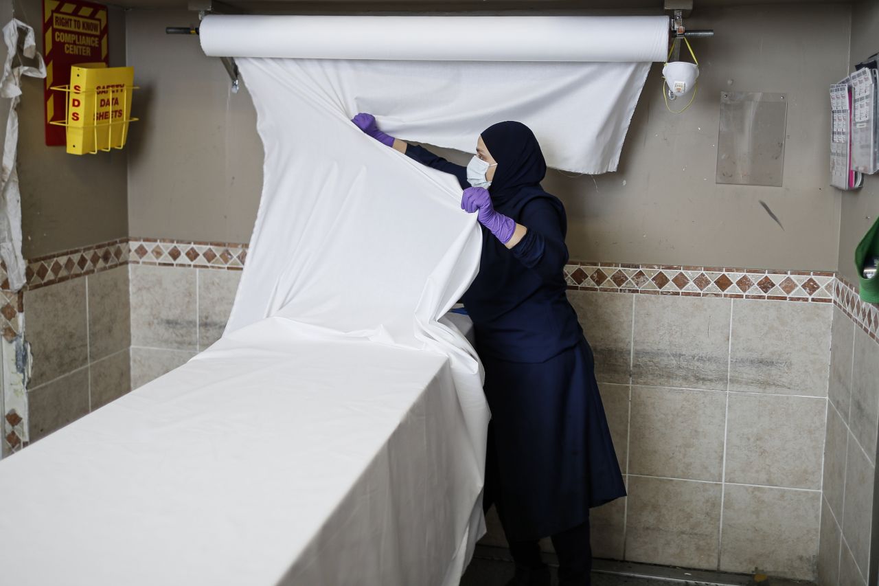 An employee prepares a surface for cleaning bodies in a religious manner at the Daniel J. Schaefer Funeral Home on Thursday, April 2.