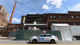 A NYPD car is parked in front of a refrigerated truck  outside of the Brooklyn Hospital on April 1, 2020 in New York City. (Photo by Angela Weiss / AFP) (Photo by ANGELA WEISS/AFP via Getty Images)