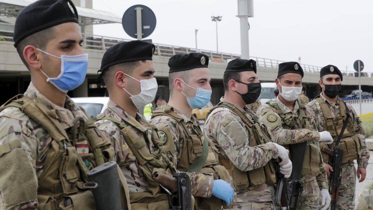 Lebanese soldiers, wearing protective equipment, stand guard at Beirut international airport on April 5, ahead of the arrival of returning nationals.