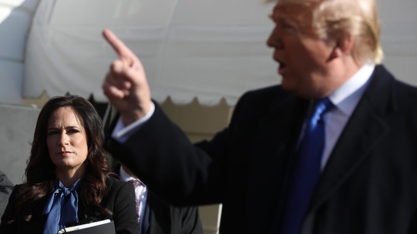 White House Press Secretary Stephanie Grisham (L) listens to U.S. President Donald Trump talk to reporters before he boards Marine One and departing the White House November 08, 2019 in Washington, DC.