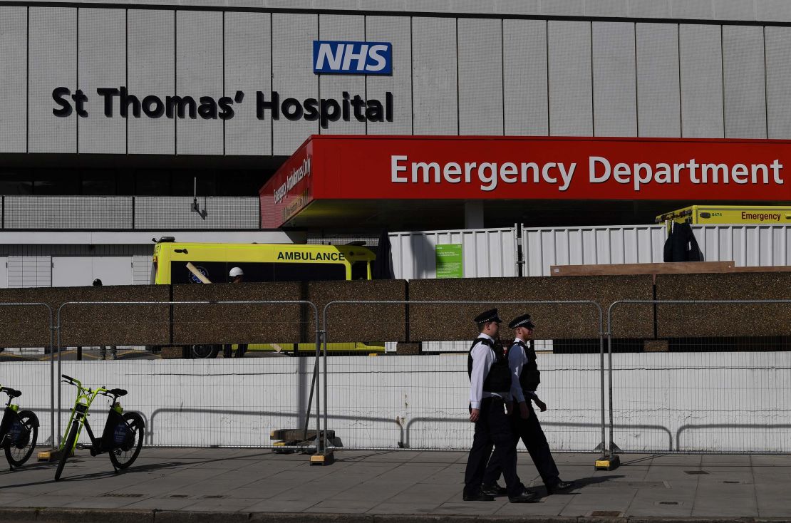 British police officers stand on duty outside St Thomas' Hospital in central London, where Britain's Prime Minister Boris Johnson is in intensive care on April 7, 2020.