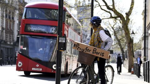 A woman with a sign of support on her bicycle in London as leaders from across the world expressed their hope that Johnson would make a rapid recovery.