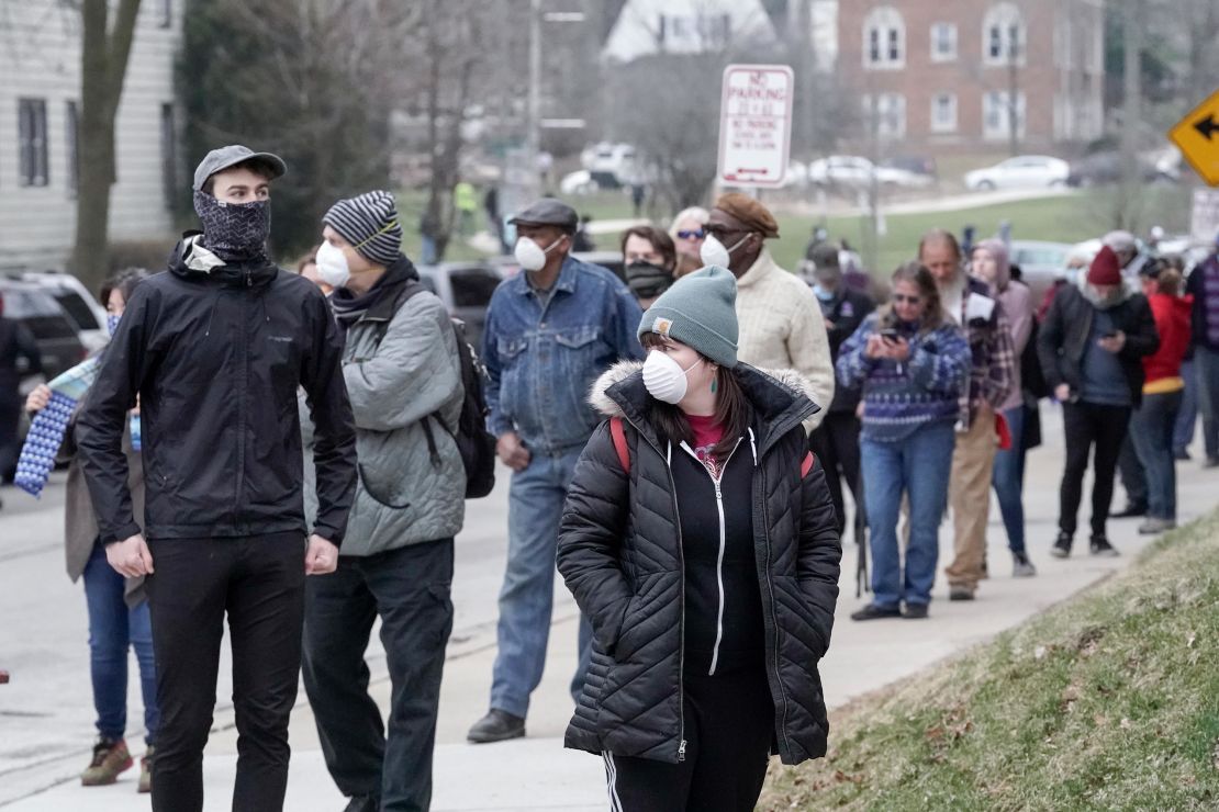 Voters line up while observing social distancing at Riverside High School in Milwaukee.