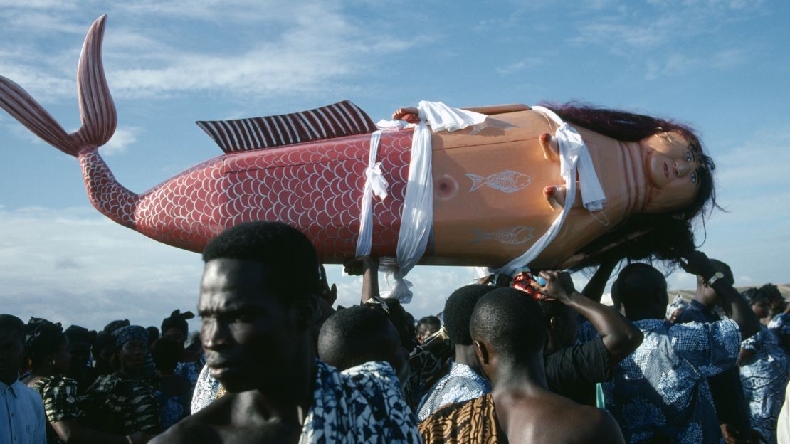 Coffin made and painted to resemble a mermaid for Ga tribal priestess of sea god carried by funeral guests.