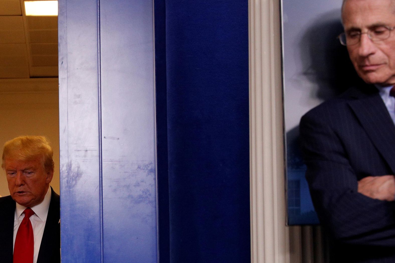 Trump arrives behind <a href="https://www.cnn.com/2020/04/02/health/gallery/anthony-fauci/index.html" target="_blank">Dr. Anthony Fauci</a> at the start of the White House's daily coronavirus briefing on March 31. Fauci is the nation's top infectious disease expert.