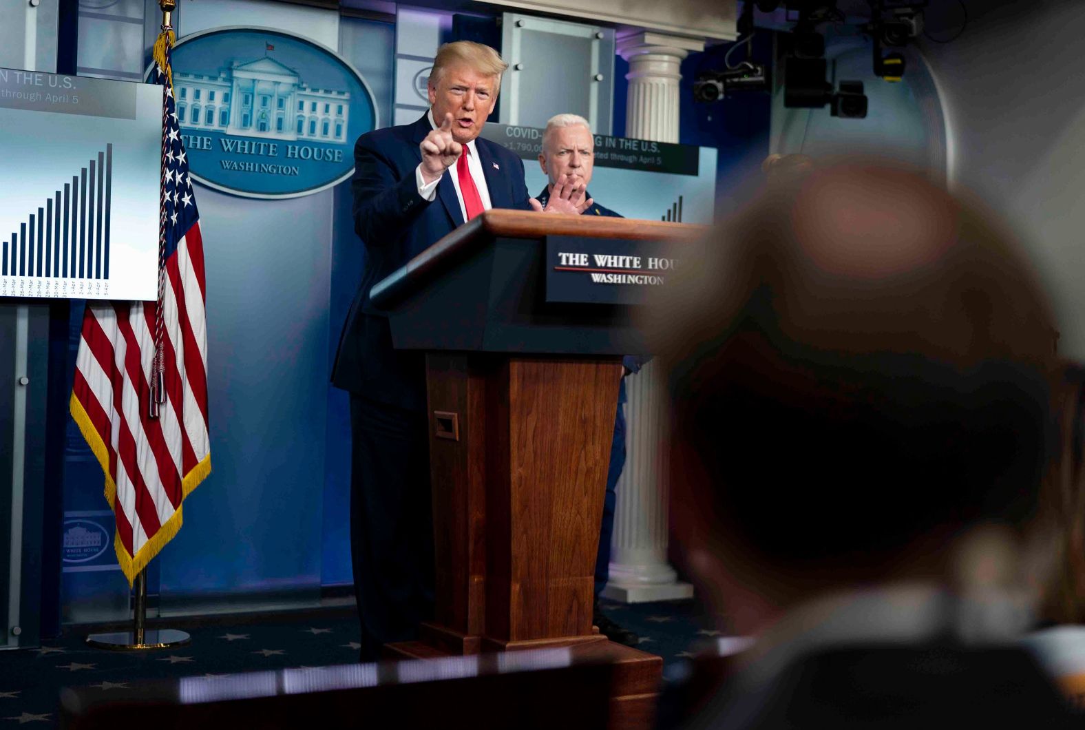 Trump speaks to members of the press during the coronavirus briefing on April 6. When asked about a <a href="index.php?page=&url=https%3A%2F%2Fwww.cnn.com%2F2020%2F04%2F06%2Fpolitics%2Fdepartment-of-health-and-human-services-shortages%2Findex.html" target="_blank">report</a> detailing the challenges US hospitals were facing as they battled the coronavirus, Trump <a href="index.php?page=&url=https%3A%2F%2Fwww.cnn.com%2F2020%2F04%2F06%2Fpolitics%2Ffact-check-trump-coronavirus-briefing-april-6%2Findex.html" target="_blank">repeatedly criticized reporters and frequently departed from his prepared text.</a> When Admiral Dr. Brett Giroir, pictured behind Trump, spoke about Covid-19 testing, he said, "I don't know the inspector general. I don't know that person." Trump then asked reporters in the room if they knew how long the inspector general had been in government. ABC News' Jonathan Karl, seated in the foreground, responded that Christi Grimm, the principal deputy inspector general for the Department of Health and Human Services, "did serve in the previous administration." Trump responded: "Oh, you didn't tell me that. Oh, I see. You didn't tell me that, Jon. You didn't tell me that. ... You mean the Obama administration. Thank you for telling me that. See, there's the typical fake-news deal. Look, you're a third-rate reporter. And what you just said is a disgrace, O.K.? ... Thank you very much, Jon. Thank you very much. You will never make it."