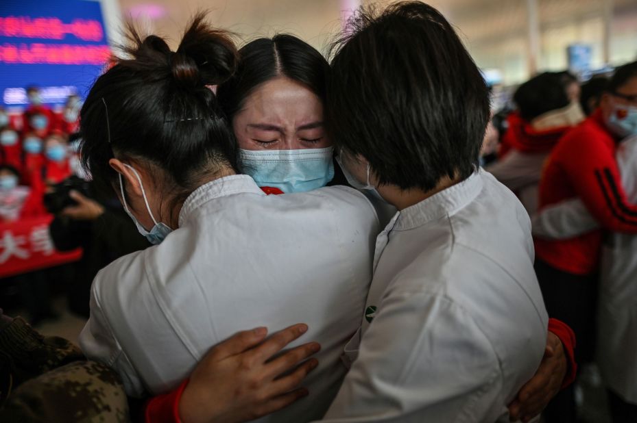 A medical staff member from China's Jilin province, center, cries while hugging nurses from Wuhan on April 8, 2020. Wuhan was <a href="https://www.cnn.com/2020/04/07/asia/coronavirus-wuhan-lockdown-lifted-intl-hnk/index.html" target="_blank">reopening its borders</a> after 76 days.