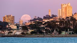 A full moon rises above the horizon in San Francisco, California on April 7, 2020.