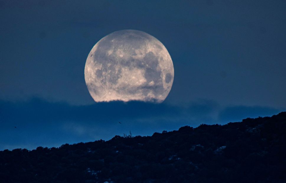The pink supermoon is seen above San Telmo in Spain's Balearic Islands in the early hours of April 8.