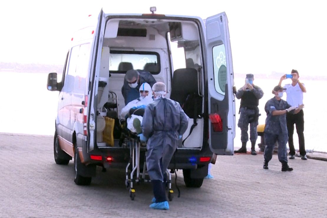 A 75-year-old Australian passenger suffering from pneumonia is seen being evacuated from the Greg Mortimer cruise liner to an ambulance in Montevideo on April 3, 2020.