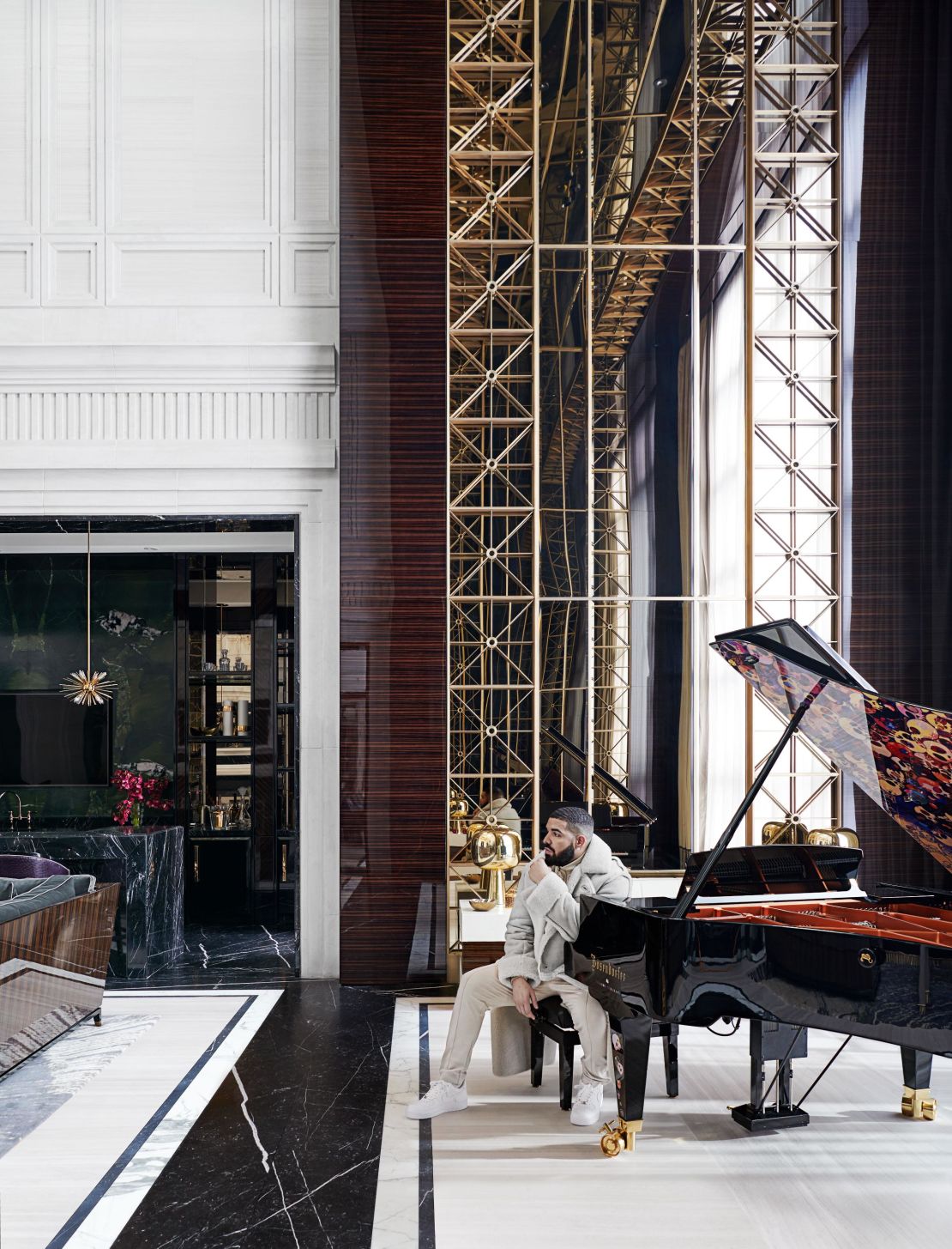 Drake in his Toronto home next to a bespoke Bösendorfer concert grand piano, designed by Ferris Rafauli and Takashi Murakami.