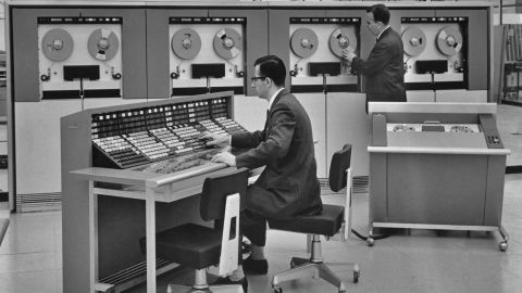 Two men operating a mainframe computer, circa 1960. 