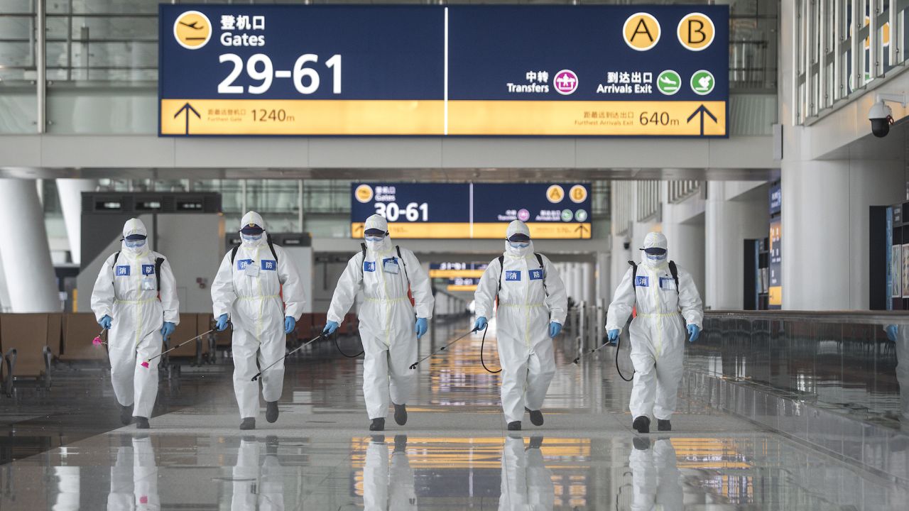 Workers disinfect an airport in Wuhan, China. While the country appears to have contained the coronavirus pandemic, Chinese overseas are facing a struggle to return home due to severe restrictions on travel. 