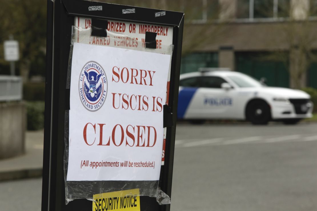 A sign showing the closure of a US Citizenship and Immigration Services (USCIS) field office in Washington. Immigrants in the US have faced uncertainty over their work visas due to the coronavirus crisis. 