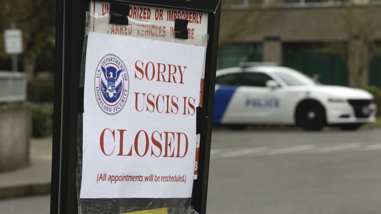 A sign showing the closure of a US Citizenship and Immigration Services (USCIS) field office in Washington. Immigrants in the US have faced uncertainty over their work visas due to the coronavirus crisis.