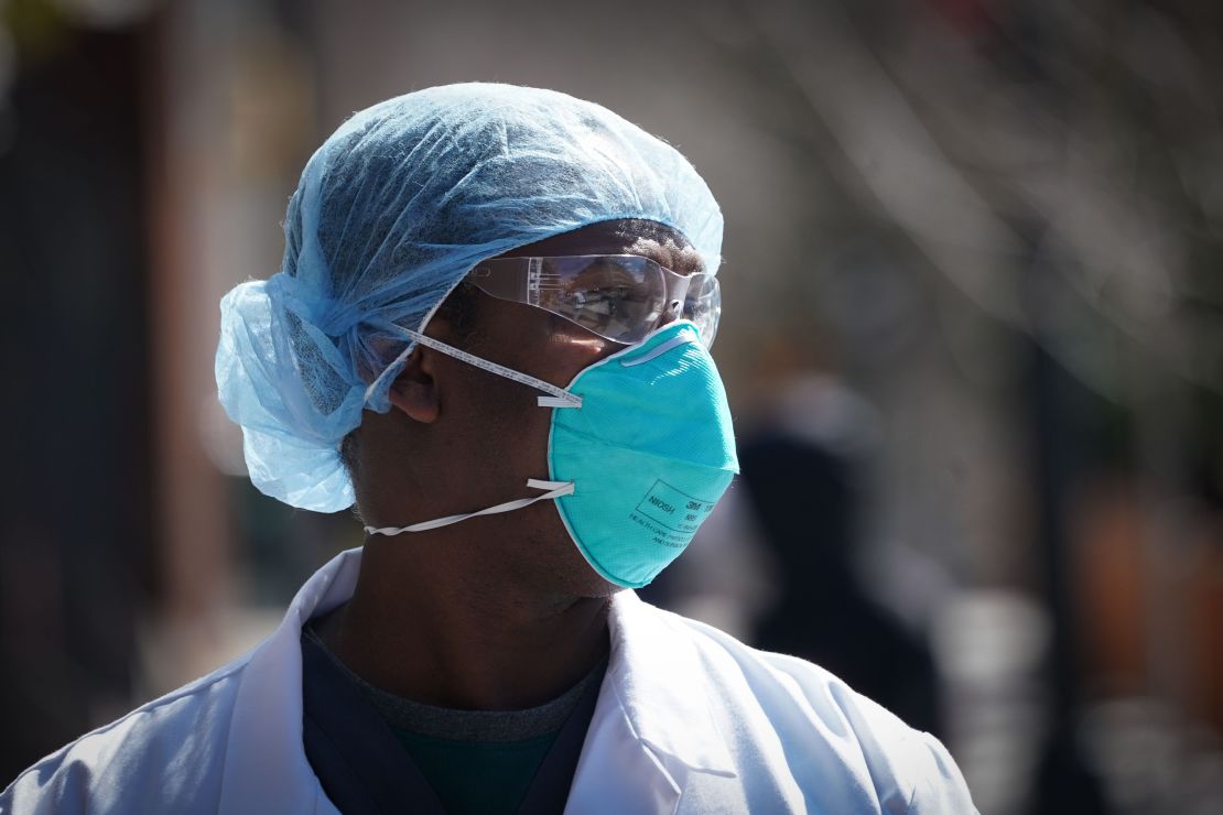 A member of the medical staff listens as Montefiore Medical Center nurses call for N95 masks and other critical PPE to handle the coronavirus pandemic on April 1, 2020 in New York. (Photo by Bryan R. Smith/AFP/Getty Images)
