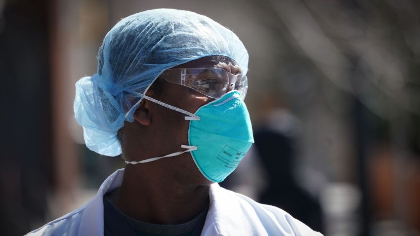 A member of the medical staff listens as Montefiore Medical Center nurses call for N95 masks and other critical PPE to handle the coronavirus (COVID-19) pandemic on April 1, 2020 in New York. - The nurses claim "hospital management is asking nurses to reuse disposable N95s after long shifts" in the Bronx. (Photo by Bryan R. Smith/AFP/Getty Images)