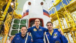 jsc2020e016986 (April 3, 2020) --- At the Baikonur Cosmodrome in Kazakhstan, Expedition 63 crewmembers Ivan Vagner (left) and Anatoly Ivanishin (center) of Roscosmos and Chris Cassidy (right) of NASA pose for pictures April 3 in front of their Soyuz spacecraft as part of their pre-launch activities. They will launch April 9 on the Soyuz MS-16 spacecraft from Baikonur on April 9 for a six-and-a-half month mission on the International Space Station. Credit: Roscosmos